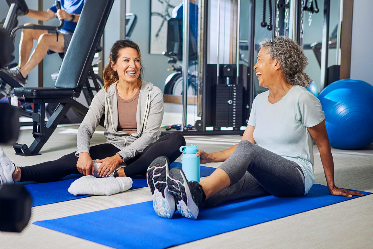 two women exercising in community fitness center