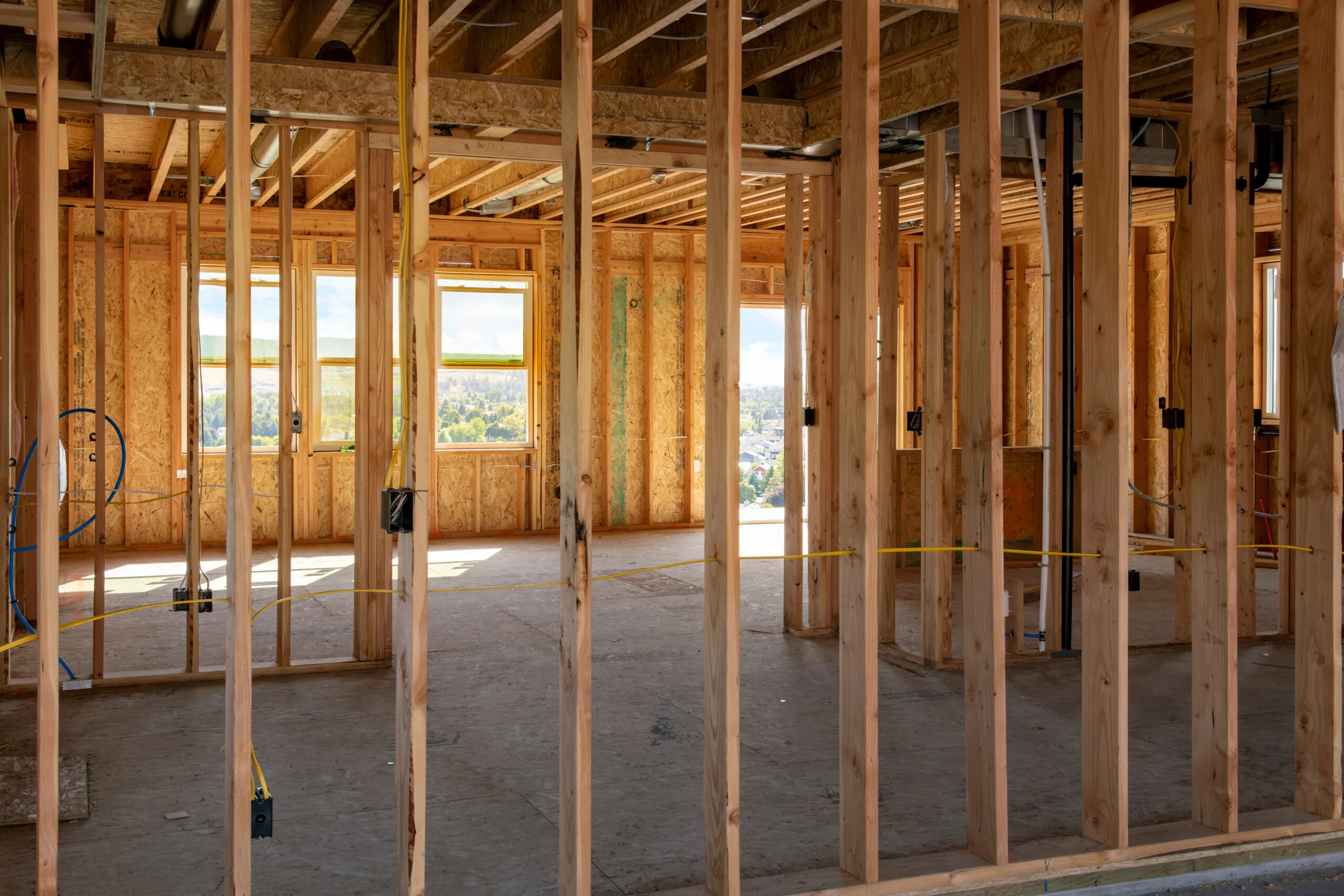 A framed new construction home being built on a hilltop overlooking the cities of Spokane and Spokane Valley.